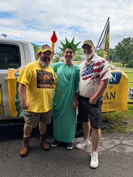 Jason Dye with Libertarian Party of Michigan allies and a Statue of Liberty mascot at a campaign event
